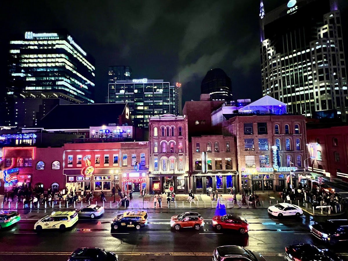 Lower Broadway in Nashville at night, neon signs and traffic