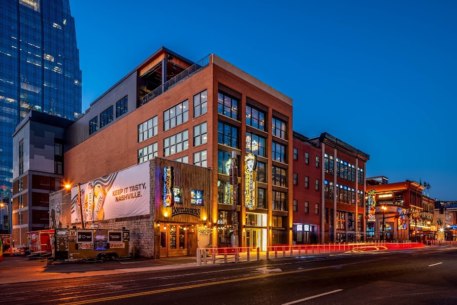 Goodnight Nashville building on Broadway at dusk, rooftop level lit up