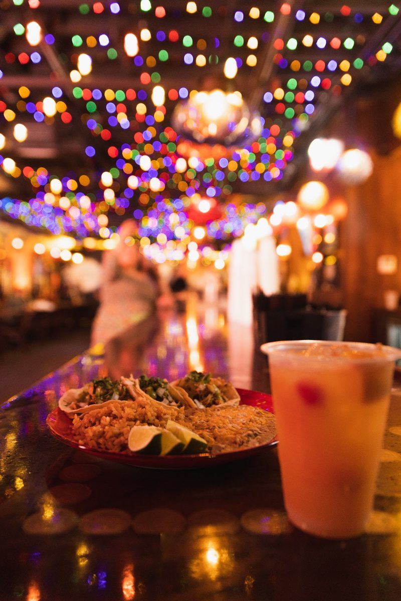 Nachos and a drink under string lights in a Nashville honky-tonk