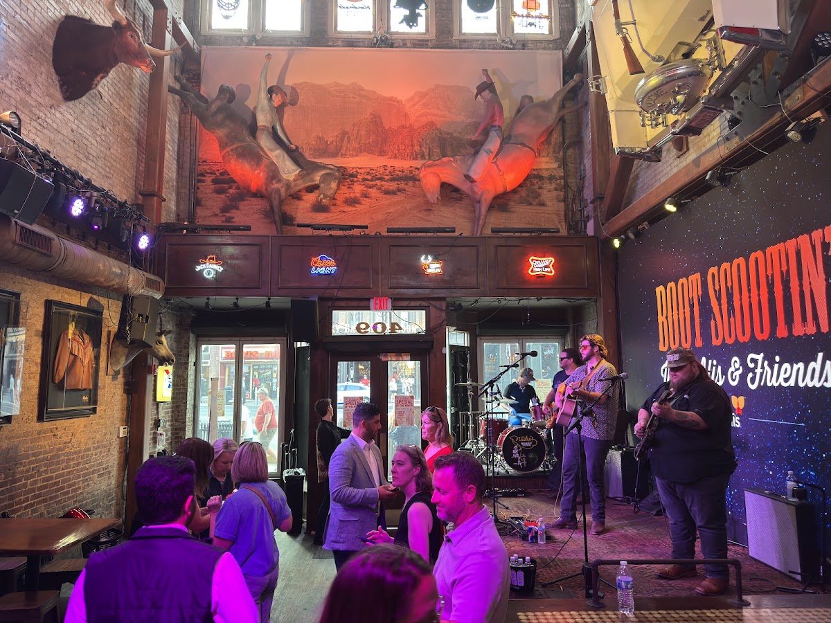A small group at the stage in a Nashville honky-tonk