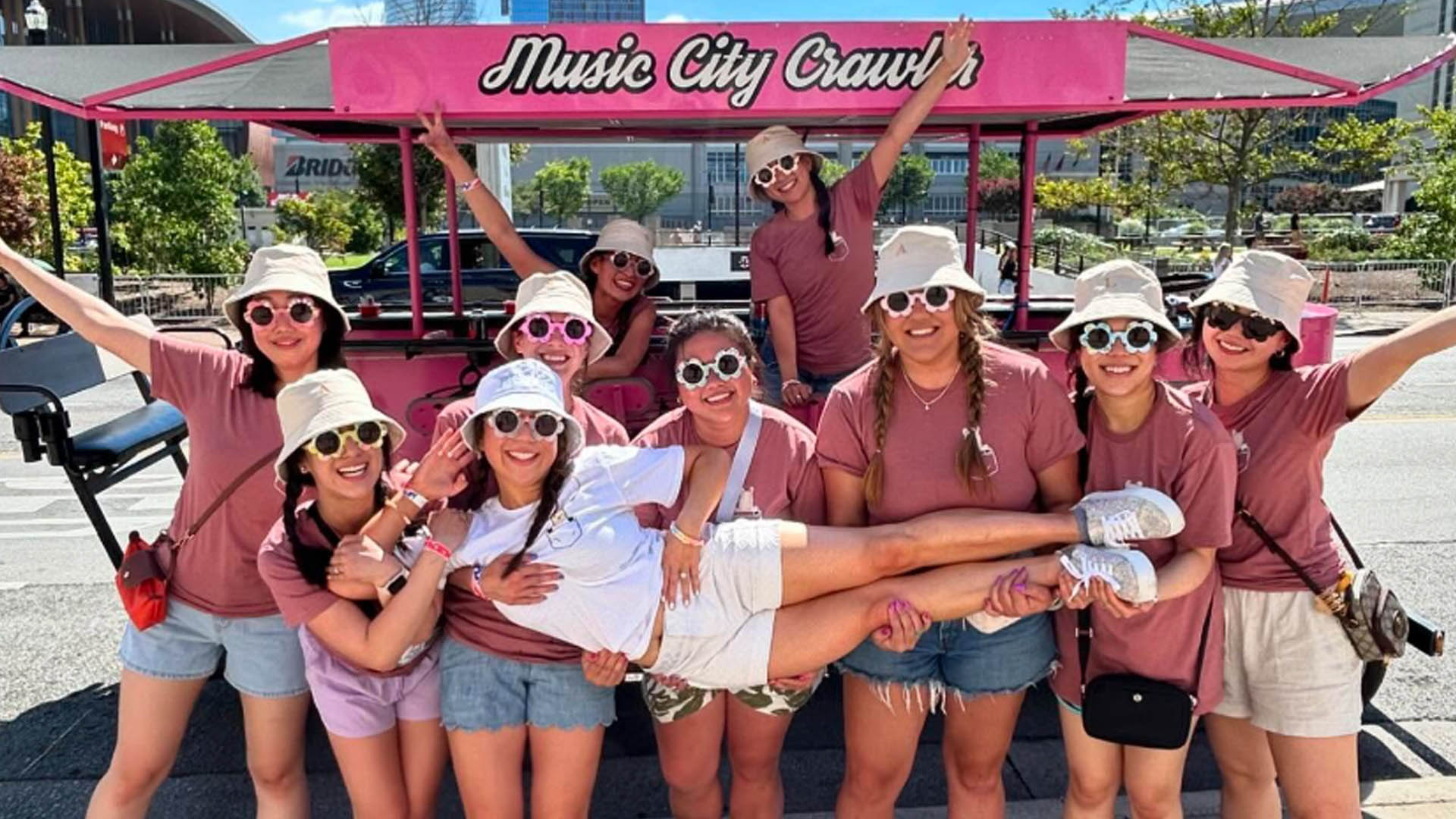 A crew in front of the Music City Crawler party bike in downtown Nashville