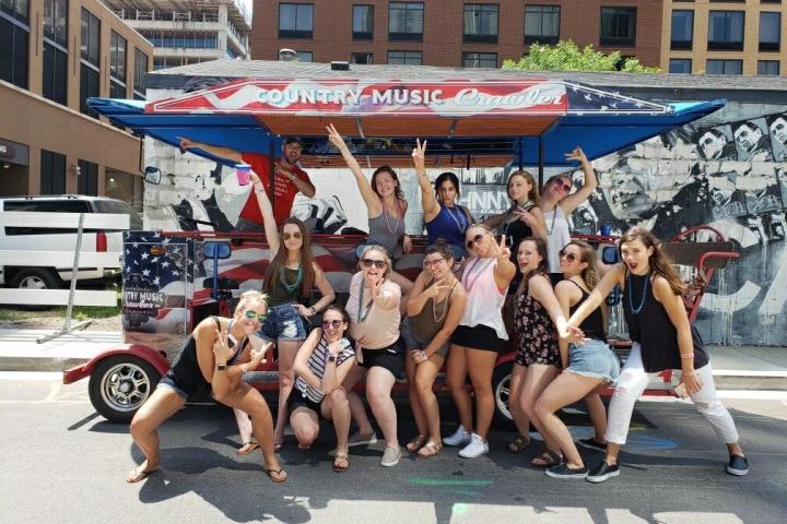 a group of people on a street in front of a crowd